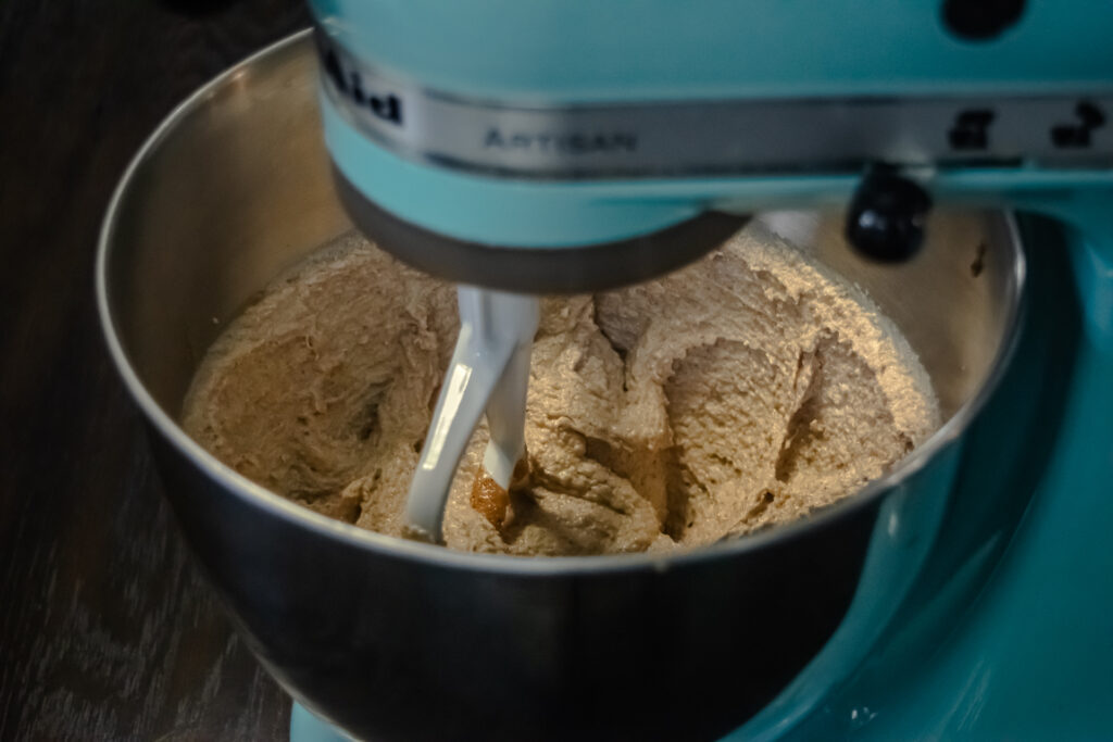Butter, eggs, and sugar being beaten in a stand mixer.